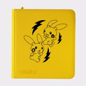 May include: Yellow card binder featuring a black cartoon rabbit design and lightning bolts. The binder has a zip closure and the word "vaultx" printed at the bottom. The binder is designed to hold trading cards.