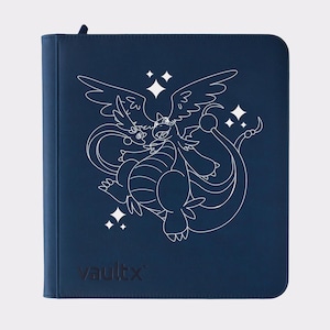 May include: A navy blue card binder featuring a white line drawing of a dragon-like creature with wings and a long tail, along with other smaller creatures and star-shaped accents. The word "vaultx" is printed in black at the bottom.