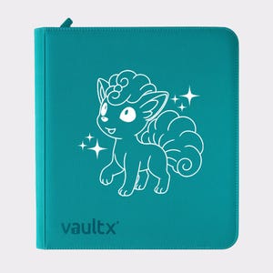 May include: Teal binder with a white outline illustration of a cartoon fox with fluffy tails and stars. The binder has a zipper closure and the word "vaultx" printed at the bottom.