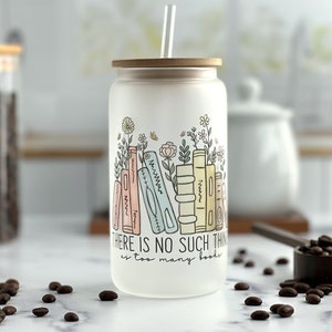 Iced coffee glass can with a graphic containing books and minimalist flowers in pastel colors. The saying there is no such thing as too many books underneath.