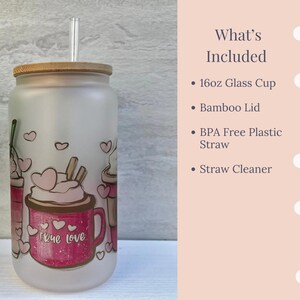 May include: A frosted glass cup with a bamboo lid and a straw. The cup has a pink and white design with the words "true love" on it. The cup is 16 ounces and comes with a straw cleaner.