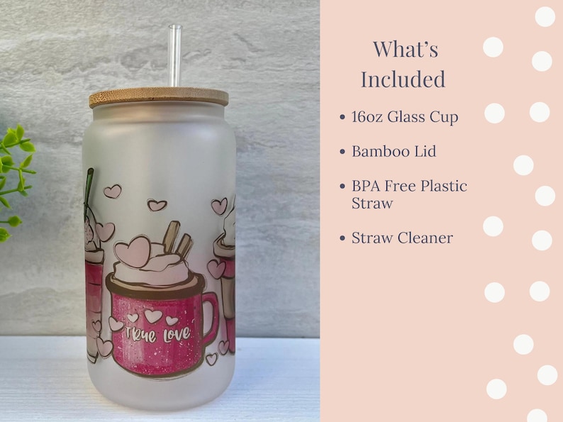May include: A frosted glass cup with a bamboo lid and a straw. The cup has a pink and white design with the words "true love" on it. The cup is 16 ounces and comes with a straw cleaner.