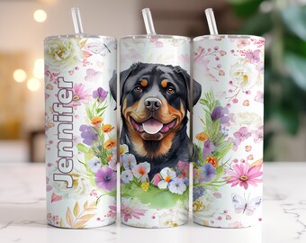 May include: A white tumbler with a floral design and a Rottweiler dog illustration. The tumbler has the name "Jennifer" printed on it.