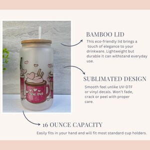 May include: A frosted glass 16 ounce tumbler with a bamboo lid and a straw. The tumbler has a pink and white design with the words "Love Love" on it.