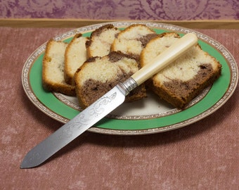 Vintage Cake Cutting cutlery utensil, featuring scrollwork and  Faux Bone handle, circa early to mid century