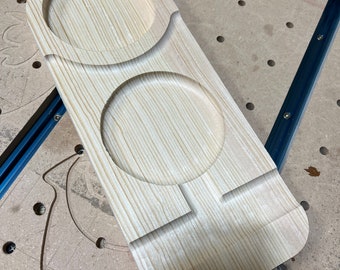 May include: A wooden serving tray with two circular cutouts, perfect for holding snacks or drinks. The tray is made of light wood and has a natural finish.