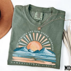 a t - shirt with a hat next to it