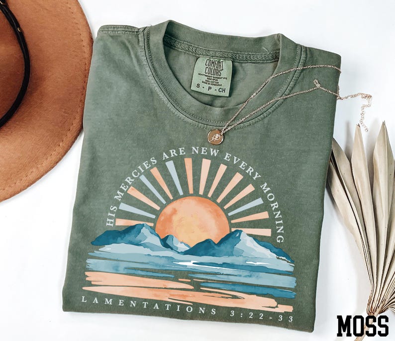a t - shirt with a hat next to it