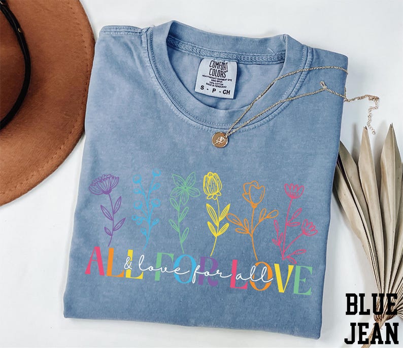a blue t - shirt with a flower design on it
