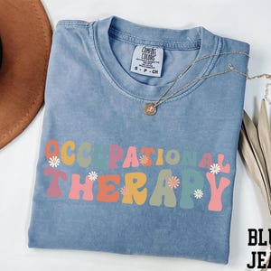 a blue shirt with the words corporation therapy on it