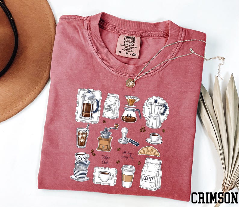 a red t-shirt with a graphic design of various coffee-related items, such as a coffee maker, coffee cup, and coffee beans, along with the text "Coffee Club".