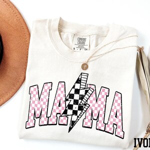 a hat, sunglasses, and t - shirt on a white surface