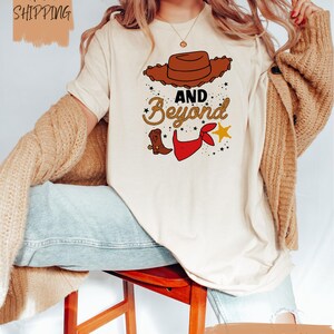 a woman sitting on a stool wearing a t - shirt