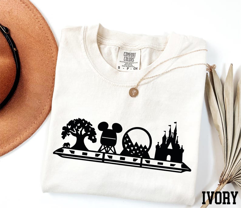 a hat, sunglasses, and t - shirt on a white surface