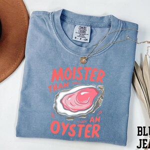a t - shirt with a picture of an oyster on it