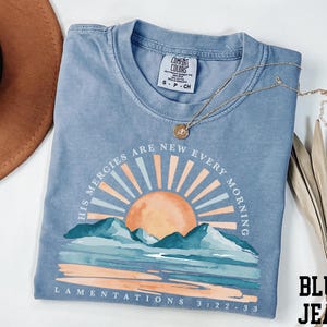 a t - shirt with a picture of a sunset on it
