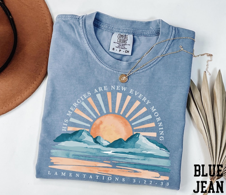 a t - shirt with a picture of a sunset on it