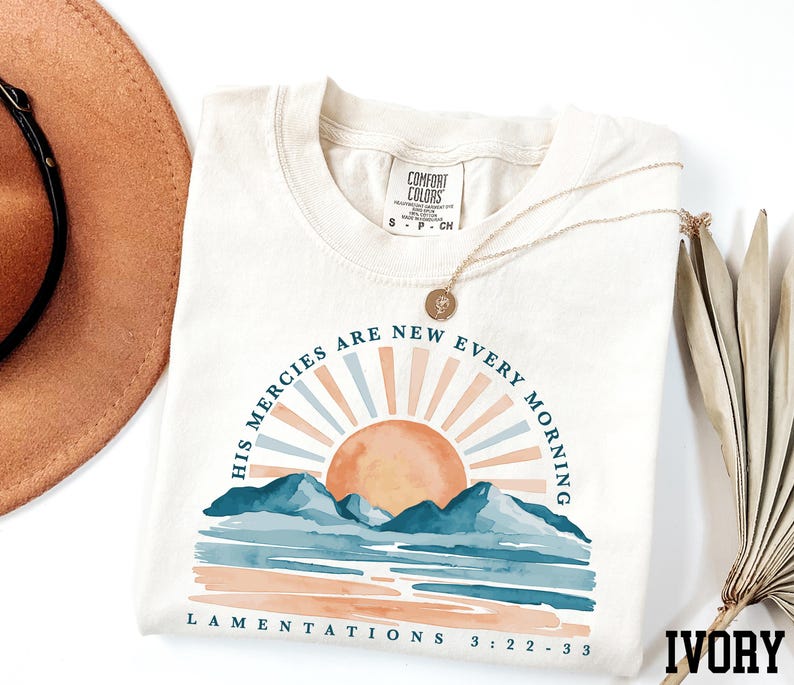 a hat, sunglasses, and t - shirt on a white surface