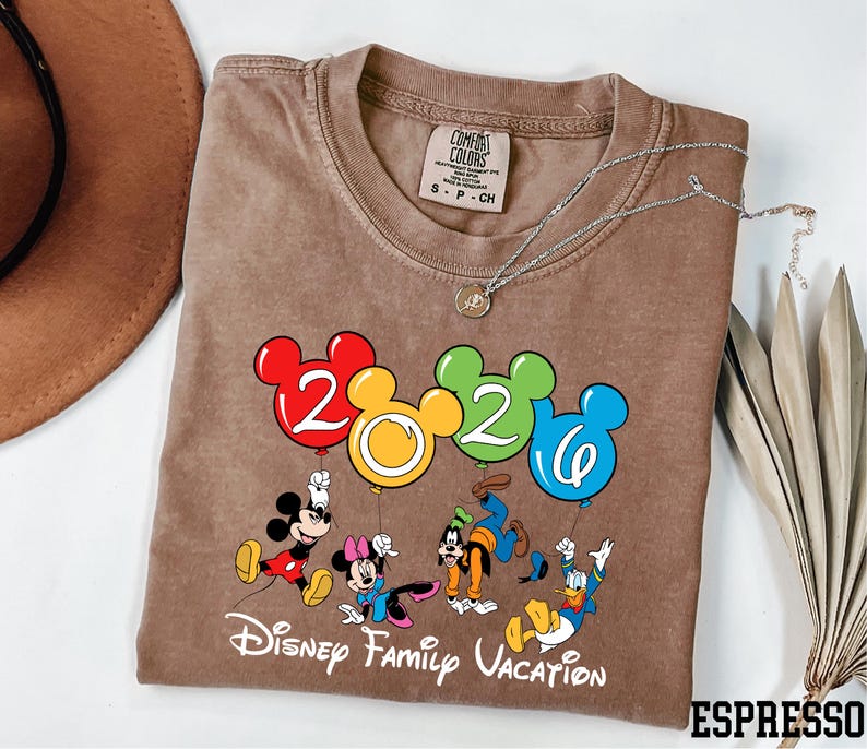 A t-shirt with a Disney-themed design, featuring Mickey Mouse and other Disney characters, along with the text "Disney Family Vacation".