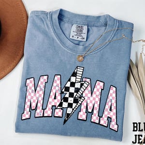 a blue shirt with a pink and white checkered design on it