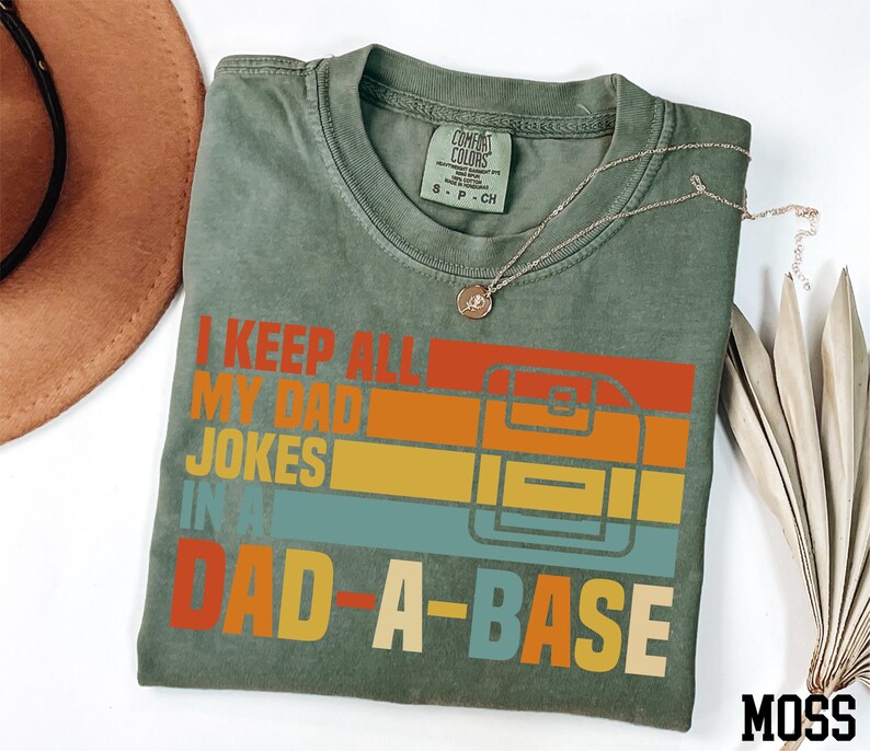 a t - shirt that says i keep all my dad jokes in dad - a