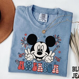 a mickey mouse tshirt with a straw hat on top of it