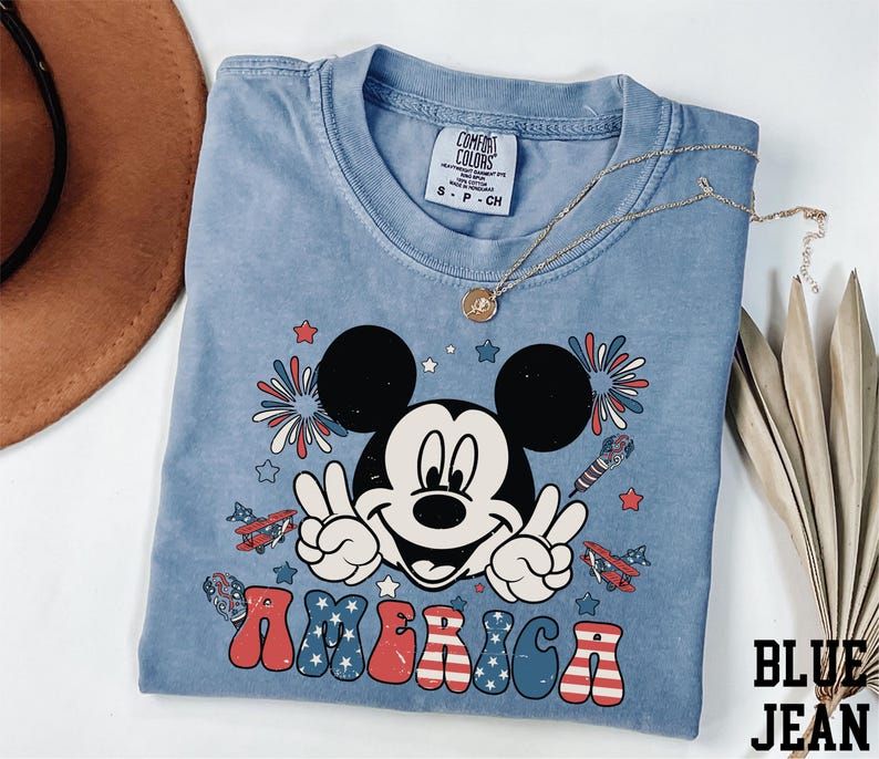 a mickey mouse tshirt with a straw hat on top of it