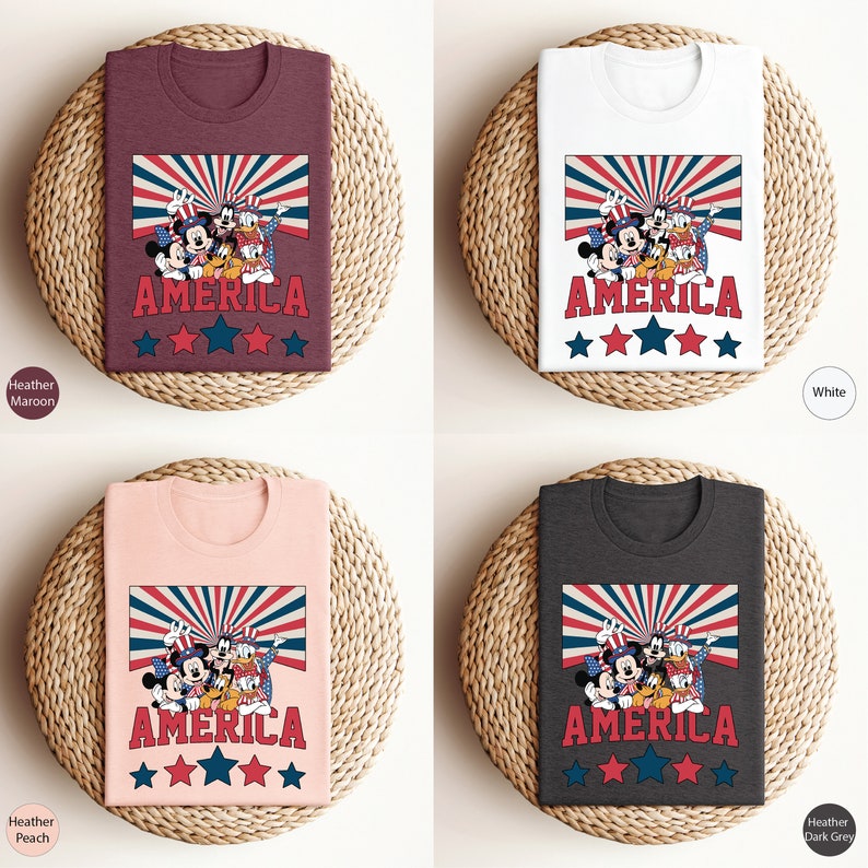 May include: Four t-shirts with a graphic of Mickey Mouse, Donald Duck, Goofy, and Pluto wearing red, white, and blue patriotic clothing. The shirts are available in Heather Maroon, White, Heather Peach, and Heather Dark Grey.