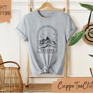a t - shirt with a picture of a mountain on it