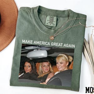 a t - shirt with a picture of two women in a car