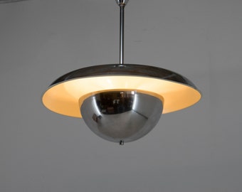 May include: A chrome and white pendant light fixture with a round, dome-shaped shade and a flat, saucer-shaped shade.
