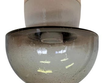 May include: A vintage, two-part ceiling light fixture. The lower, bowl-shaped shade is a smoky gray glass with small bubbles. The upper portion is a cylindrical, off-white ceramic piece. The fixture is designed to be mounted flush against the ceiling.