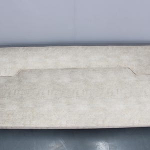 May include: A white fabric sofa bed with a tufted design. The sofa bed is folded in half, with the back of the sofa bed facing the camera.