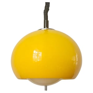 May include: A bright yellow pendant light fixture with a rounded, dome-shaped shade. The shade is glossy and reflects light. The fixture has a black cord and a white, semi-spherical bottom element.