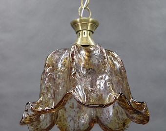 May include: A vintage pendant light fixture with a flower-shaped glass shade. The shade is a mix of brown and gold tones with a speckled pattern. The fixture has a brass-colored metal top and chain.