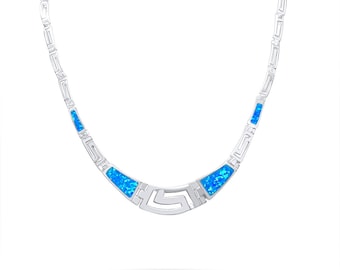 May include: A silver necklace with a geometric design and blue opal accents.
