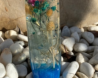 Botón de cambio con flores azules, verdes, amarillas y rosadas