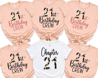 May include: Six t-shirts with a leopard print design. Five of the shirts are peach colored and say "21st Birthday Crew" in black text with a pink "st". One shirt is white and says "Chapter 21" in black text with a leopard print 21.