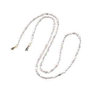 May include: A white pearl necklace with a flowing design. The necklace is made of small, irregular-shaped pearls strung together. Gold-coloured clasps are visible at each end. The necklace is designed to be worn around the neck.