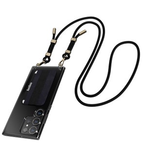 May include: A clear phone case with a black and navy blue card holder and a black lanyard. The lanyard has gold-colored metal accents and a black cord. The phone case has a camera and the brand name "keebos" is visible on the card holder.