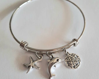 Stainless steel bangle bracelet, beach themed, dolphin bracelet. Starfish bracelet, sand dollar bracelet, charm bracelet