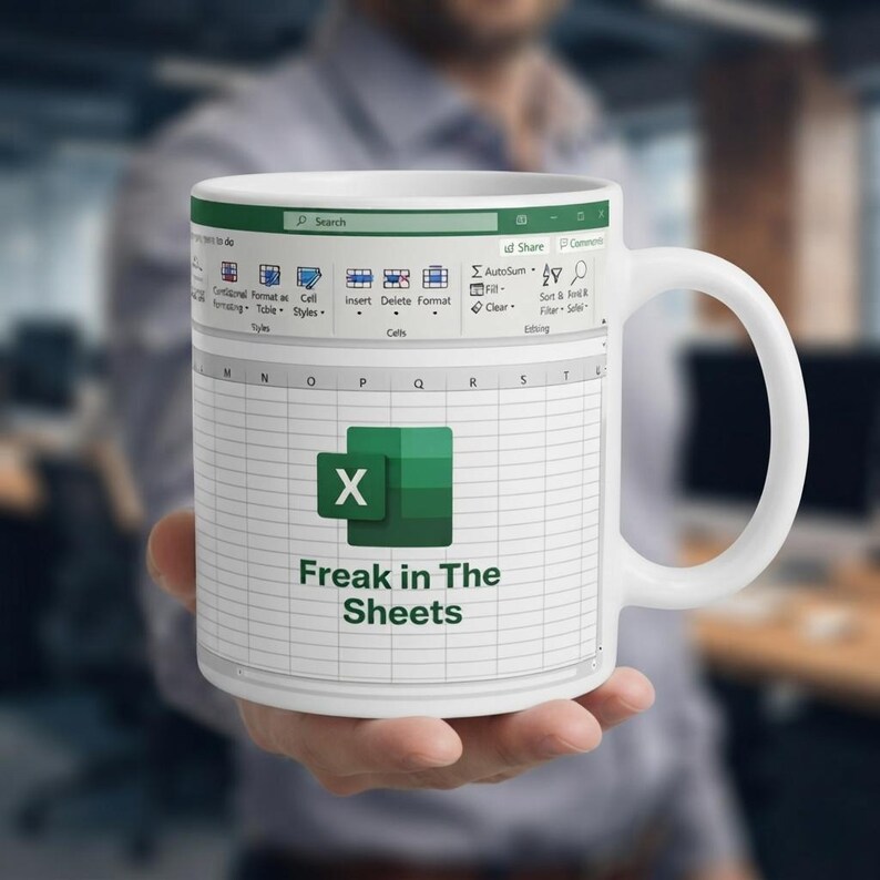 May include: A white ceramic mug featuring a printed graphic of a spreadsheet interface. The design includes the Microsoft Excel logo and the text "Freak in The Sheets" centered over a grid of cells, with a toolbar visible at the top of the mug.