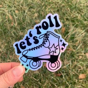 May include: A holographic sticker with a black outline of a roller skate and the text "let's roll".