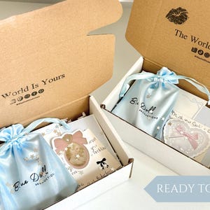 Gold angel necklace packaged in Blue Doll signature gift box with satin jewelry pouch ready for gifting