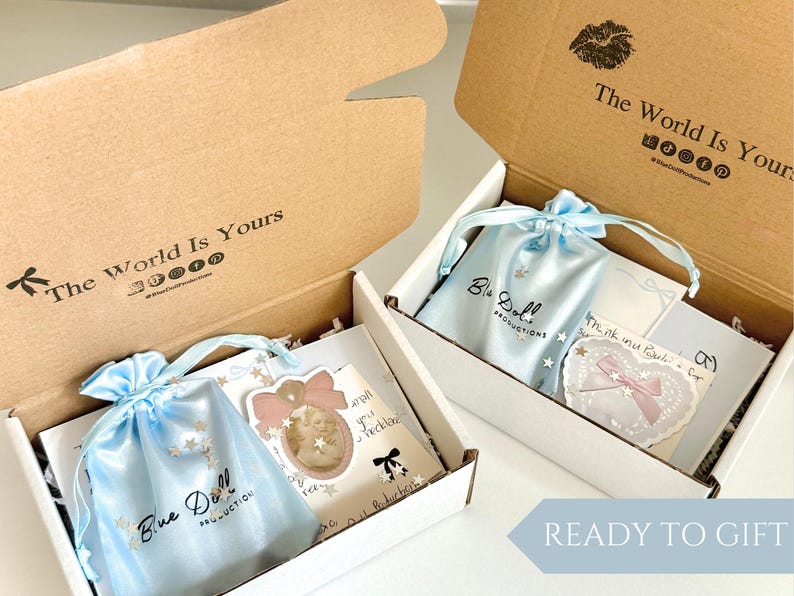 Gold angel necklace packaged in Blue Doll signature gift box with satin jewelry pouch ready for gifting
