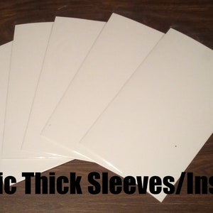 May include: Five white comic book sleeves or inserts. The sleeves are made of a thick, durable material and are designed to protect comic books from damage.