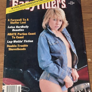 May include: A magazine cover featuring a woman wearing a denim jacket and denim shorts. The magazine is titled "Easy Riders" and the cover text includes "$100,000 Sweepstakes!" and "3 Harleys, Ford Pickup, 5 Stereos, 100 Leathers and 1750 Other Goodies!"