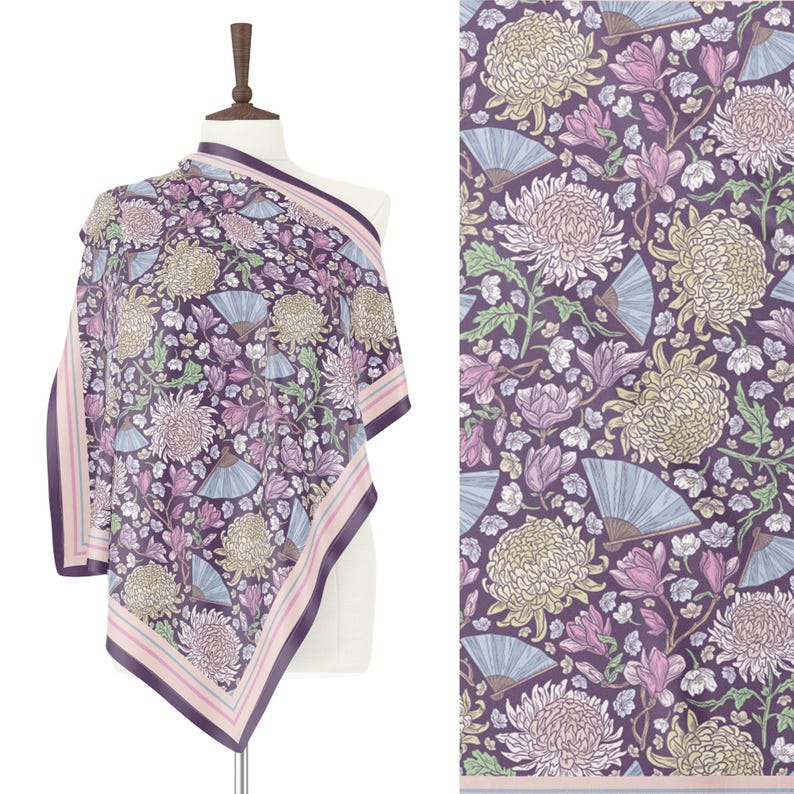 May include: A square scarf with a floral pattern featuring large chrysanthemums, fans, and other flowers in shades of purple, pink, and cream. The scarf has a dark purple border with pink and white stripes. The scarf is draped over a mannequin.