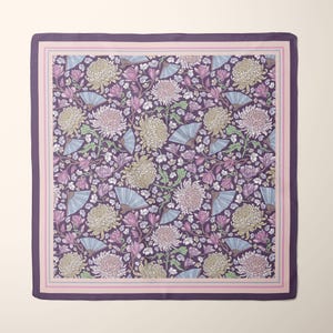 May include: Square scarf with a floral pattern featuring large chrysanthemum blooms, fans, and foliage in shades of purple, pink, and cream. The scarf has a dark purple border and a light pink and purple striped inner border.