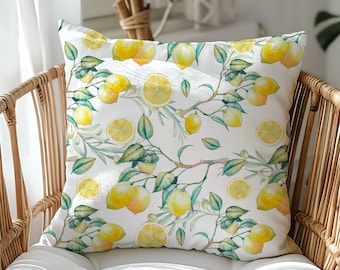 May include: A white throw pillow with a lemon print. The pillow features a watercolor design of lemons on branches with green leaves.